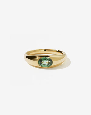 An 18ct yellow gold ring with a central oval cut green sapphire Swiss set in a smooth, rounded band.
