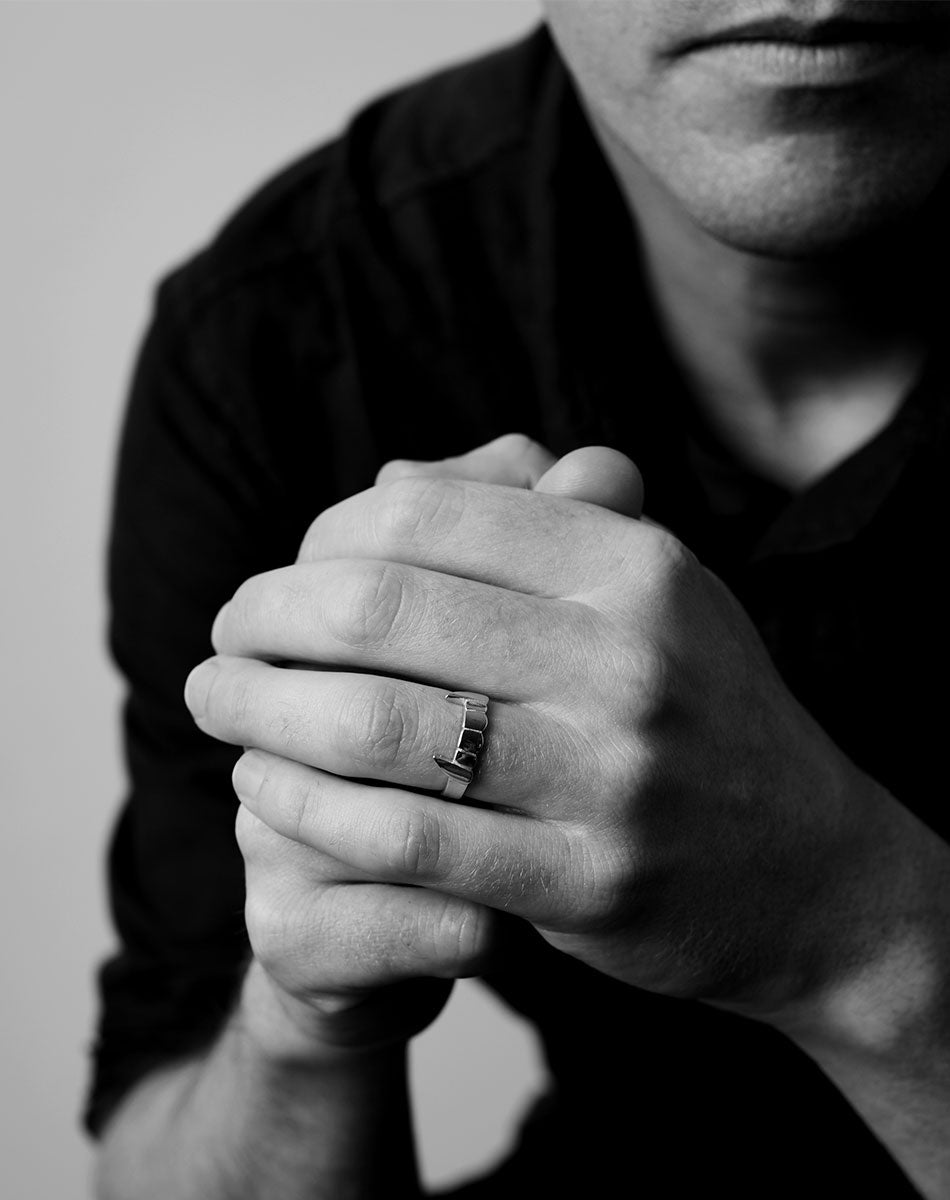Fang ring worn on a hand.