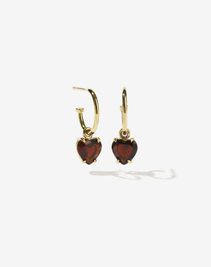 A pair of heart-shaped garnet earrings set in a claw setting, suspended from small hoop earrings, crafted in 9ct solid gold.