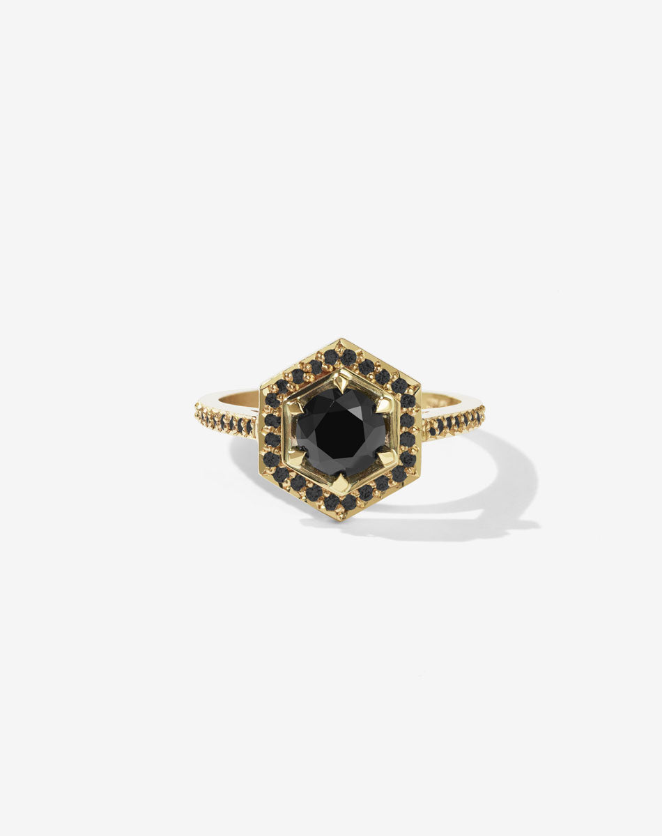 Meadowlark Jewellery’s iconic Hex Engagement Ring in 18ct Yellow Gold, claw set with 1.08ct round brilliant cut black diamond centre stone, surrounded by a hexagon halo of pave set white diamonds. Finished with a fine square band, diamond pave set halfway. One of our most beloved and modern Ceremonial designs, made to order in New Zealand. Pair with our bestseller, the Diamond Eternity Band.