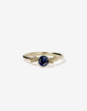 Meadowlark Jewellery’s iconic Alba Engagement Ring in 14ct Yellow Gold, claw set with a round brilliant cut blue sapphire. Round band adorned with flowers, set with round brilliant cut white diamonds. Pair with our bestseller, the Alba Band Stone Set or Plain. Made in New Zealand.