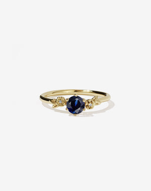 Meadowlark Jewellery’s iconic Alba Engagement Ring in 18ct Yellow Gold, claw set with a round brilliant cut blue sapphire. Round band adorned with flowers, set with round brilliant cut white diamonds. Pair with our bestseller, the Alba Band Stone Set or Plain. Made in New Zealand.