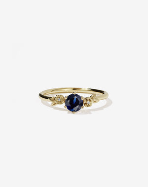 Meadowlark Jewellery’s iconic Alba Engagement Ring in 9ct Yellow Gold, claw set with a round brilliant cut blue sapphire. Round band adorned with flowers, set with round brilliant cut white diamonds. Pair with our bestseller, the Alba Band Stone Set or Plain. Made in New Zealand.