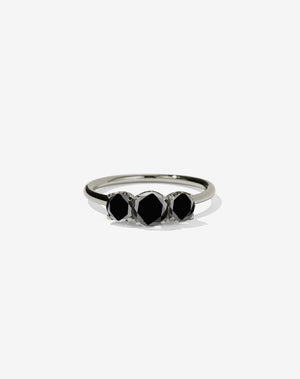 A classic three stone engagement ring in white gold with black diamonds.