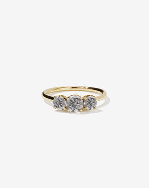 A classic three stone engagement ring in yellow gold with grey diamonds.