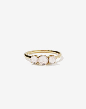 A classic three stone engagement ring in yellow gold with morganites.
