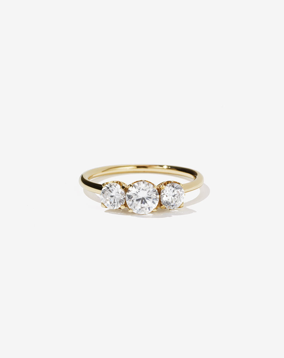 A classic three stone engagement ring in yellow gold with diamonds.