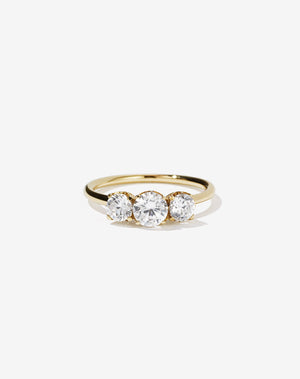 A classic three stone engagement ring in yellow gold with diamonds.
