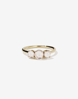 A classic three stone engagement ring in yellow gold with morganites.