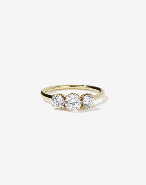 A classic three stone engagement ring in yellow gold with diamonds.