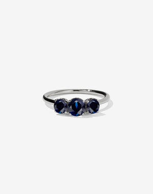 A classic three stone engagement ring in platinum with blue sapphires.
