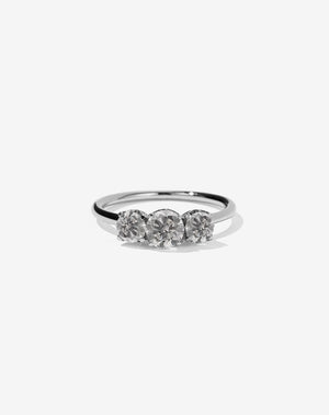 A classic three stone engagement ring in platinum with grey diamonds.