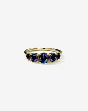 A classic yellow gold, five stone diamond engagement ring. Set with blue sapphires.