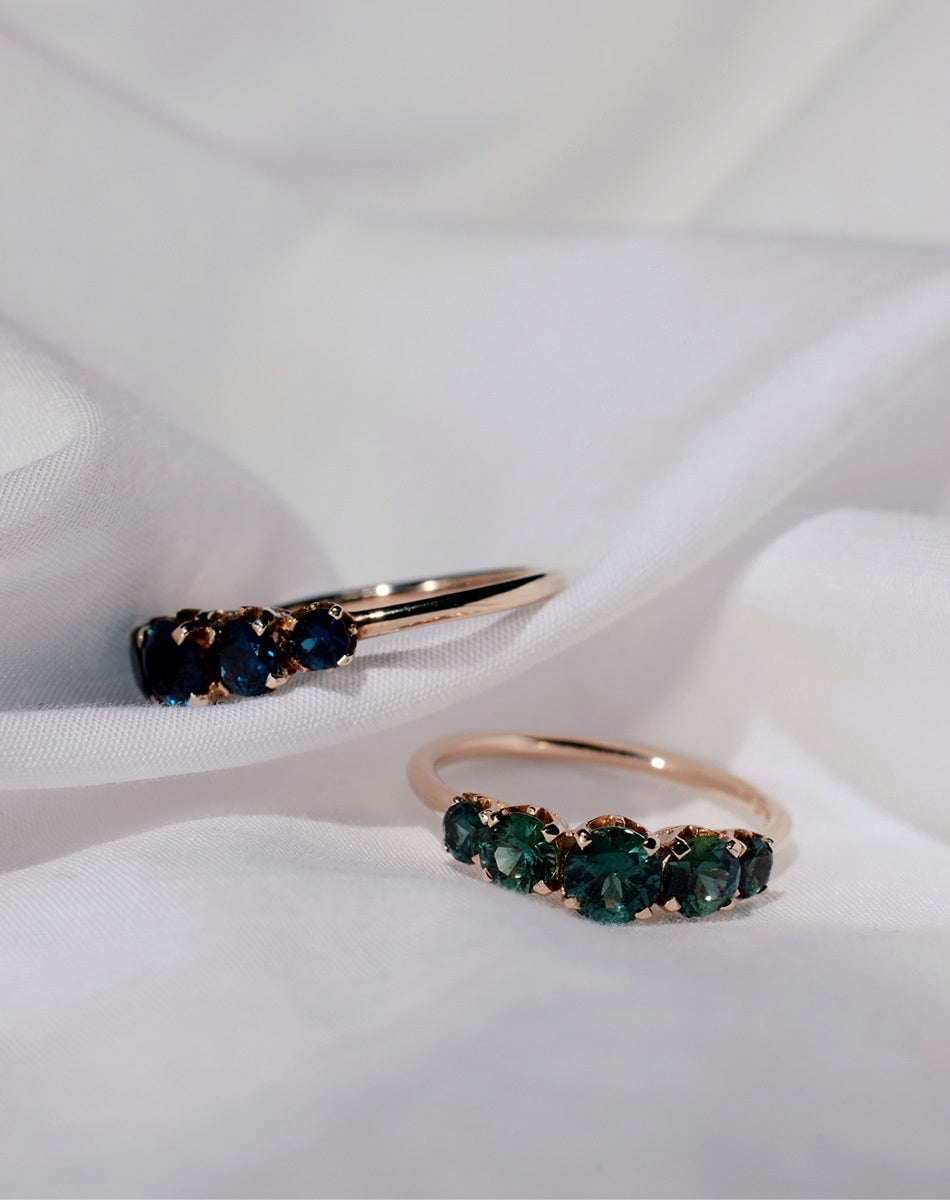 Meadowlark Jewellery’s classic Signature 5 Stone Engagement Ring in 9ct Yellow Gold, with round brilliant cut blue and green sapphires. Fully traceable and ethically sourced blue and green sapphires from Queensland, Australia. Set into our signature Meadowlark claw setting, featuring graphic lines inspired by our insignia. Pair with our bestseller, the Amelie Band Pave or Plain. One of our most timeless and beloved Ceremonial designs, made in New Zealand.