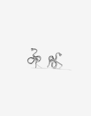 A pair of sterling silver stud earrings in a minimalist snake design
